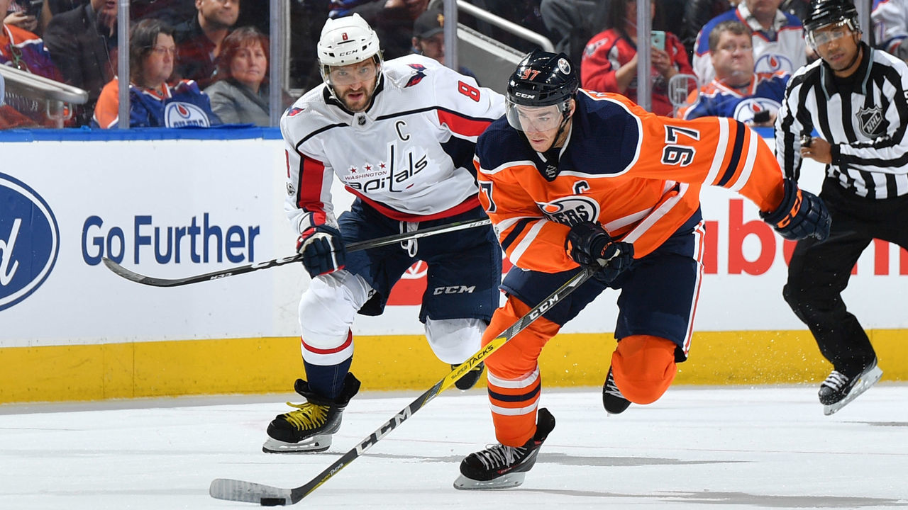 EDMONTON, AB - OCTOBER 28: Connor McDavid #97 of the Edmonton Oilers skates with the puck while being pursued by Alex Ovechkin #8 of the Washington Capitals on October 28, 2017 at Rogers Place in Edmonton, Alberta, Canada.