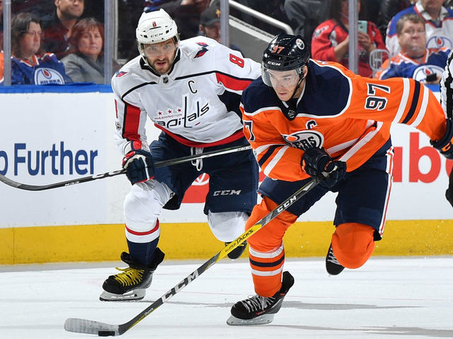 EDMONTON, AB - OCTOBER 28: Connor McDavid #97 of the Edmonton Oilers skates with the puck while being pursued by Alex Ovechkin #8 of the Washington Capitals on October 28, 2017 at Rogers Place in Edmonton, Alberta, Canada.