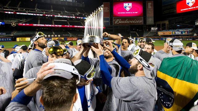 NEW YORK, NY - NOVEMBER 1: Members of the Kansas City Royals hoist up the Commissioner's Trophy on the field after defeating the New York Mets in Game 5 of the 2015 World Series at Citi Field on Sunday, November 1, 2015 in the Queens borough of New York City.
