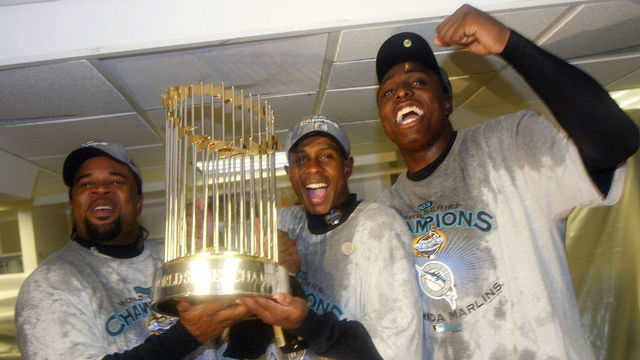 BRONX, NY - OCTOBER 25: (L-R) Lenny Harris #10, Juan Pierre #9 and Dontrelle Willis #35 of the Florida Marlins celebrate after defeating the New York Yankees 2-0 in game six to win the 2003 Major League Baseball World Series on October 25, 2003 at Yankee Stadium in the Bronx, New York.