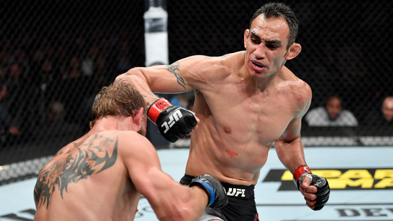CHICAGO, IL - JUNE 08: (R-L) Tony Ferguson punches Donald Cerrone in their lightweight bout during the UFC 238 event at the United Center on June 8, 2019 in Chicago, Illinois.