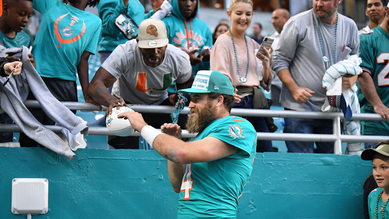 MIAMI, FLORIDA - DECEMBER 22: Ryan Fitzpatrick #14 of the Miami Dolphins celebrates with fans in the stands after the game against the Cincinnati Bengals at Hard Rock Stadium on December 22, 2019 in Miami, Florida.