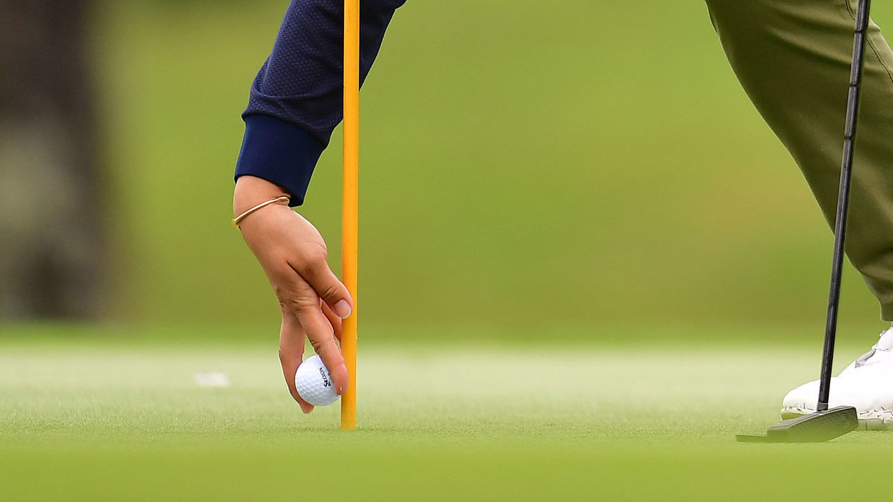 NANJO, JAPAN - MARCH 08: Misuzu Narita of Japan picks up her ball on the 18th hole during the second round of the Daikin Orchid Ladies Golf Tournament at Ryukyu Golf Club on March 08, 2019 in Nanjo, Okinawa, Japan.