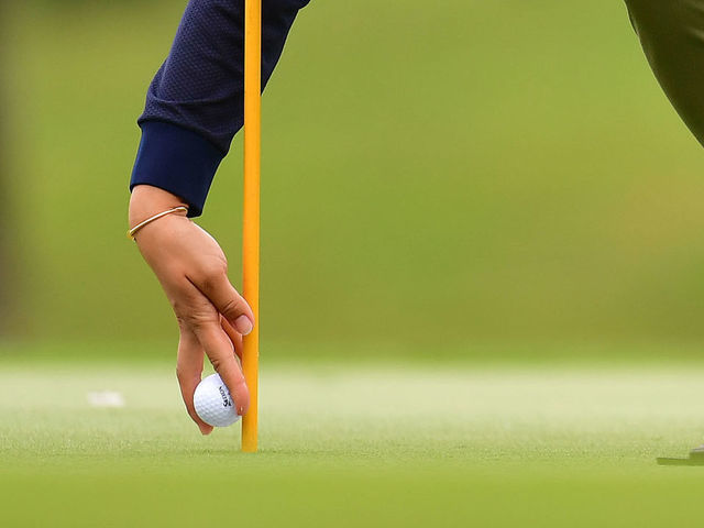 NANJO, JAPAN - MARCH 08: Misuzu Narita of Japan picks up her ball on the 18th hole during the second round of the Daikin Orchid Ladies Golf Tournament at Ryukyu Golf Club on March 08, 2019 in Nanjo, Okinawa, Japan.