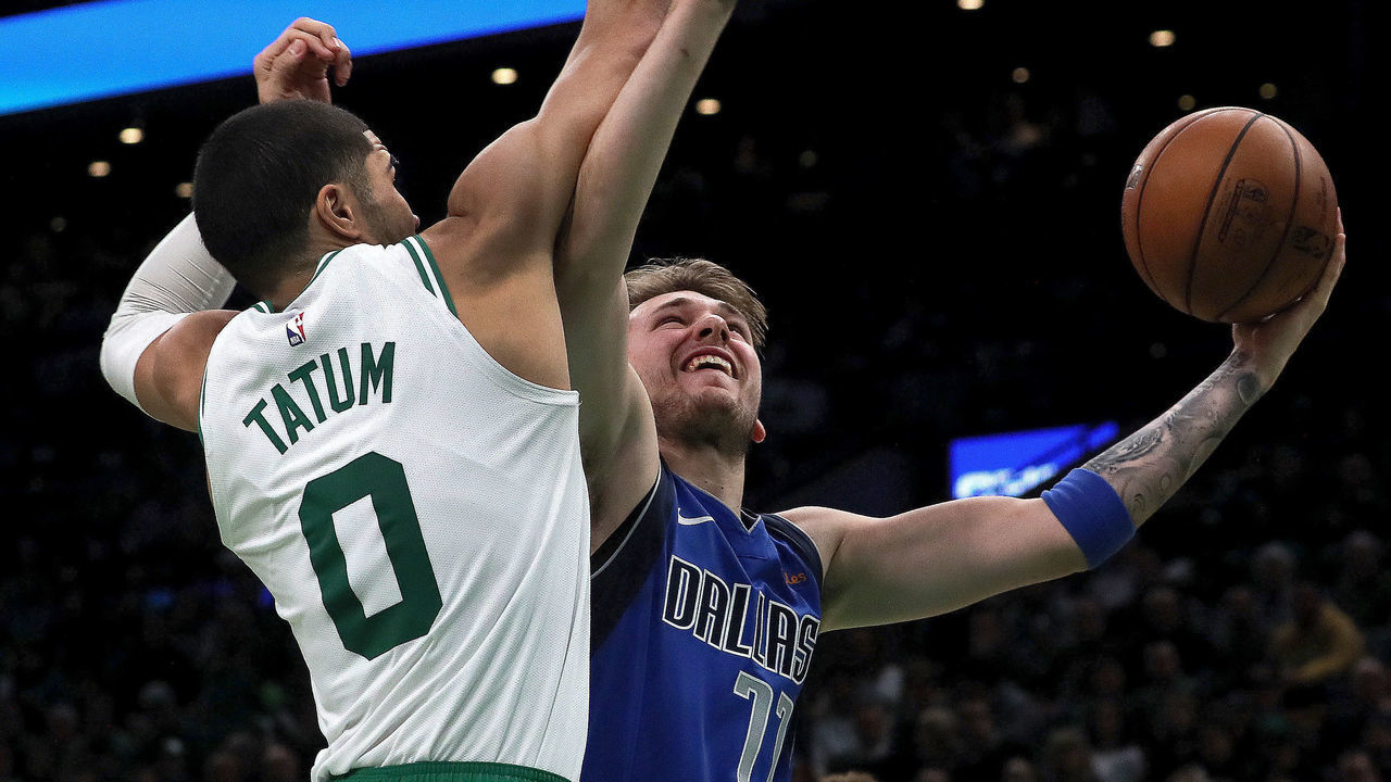 BOSTON - JANUARY 4: Boston Celtics forward Jayson Tatum (0) goes for the block on Dallas Mavericks forward Luka Doncic (77) during the fourth quarter. The Boston Celtics host the Dallas Mavericks in a regular season NBA basketball game at TD Garden in Boston on Jan. 4, 2019.