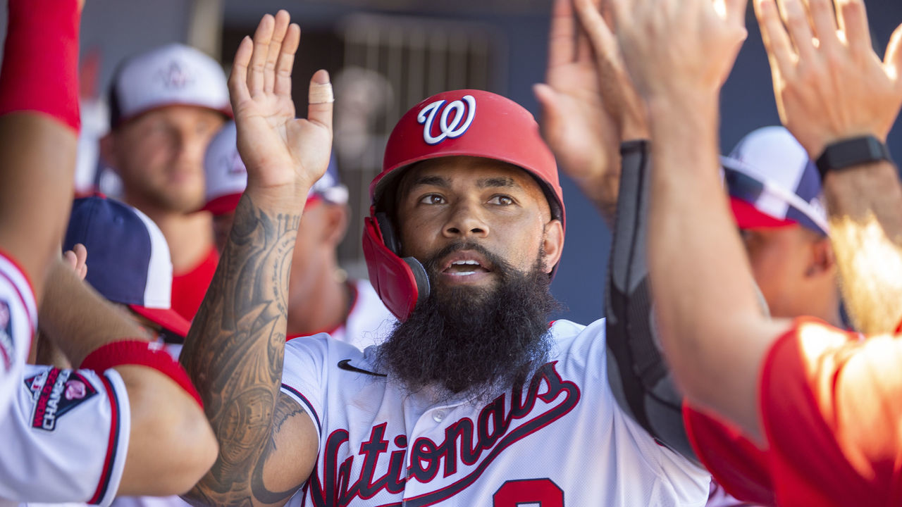 WEST PALM BEACH, FL - MARCH 12: Washington Nationals Outfielder Eric Thames (9) high fives teammates in the dugout as he celebrates scoring a run during an MLB spring training game between the New York Yankees and the Washington Nationals at The FITTEAM Ballpark of the Palm Beaches in West Palm Beach, Florida on March 12, 2020. Following this game, Major League Baseball suspended spring training games in response to the Coronavirus pandemic.