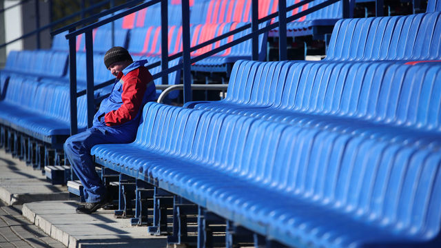 MINSK, RUSSIA - MAY 1, 2020: A football fans sits in an empty stand during a 2020 Belarusian Premier League (women) Round 1 football match between FC Minsk and FC Dnepr Mogilev at FC Minsk Stadium. FC Minsk won 10-0. The Football Federation of Belarus has decided not to postpone national football championships in connection with the COVID-19 pandemic. Natalia Fedosenko/TASS