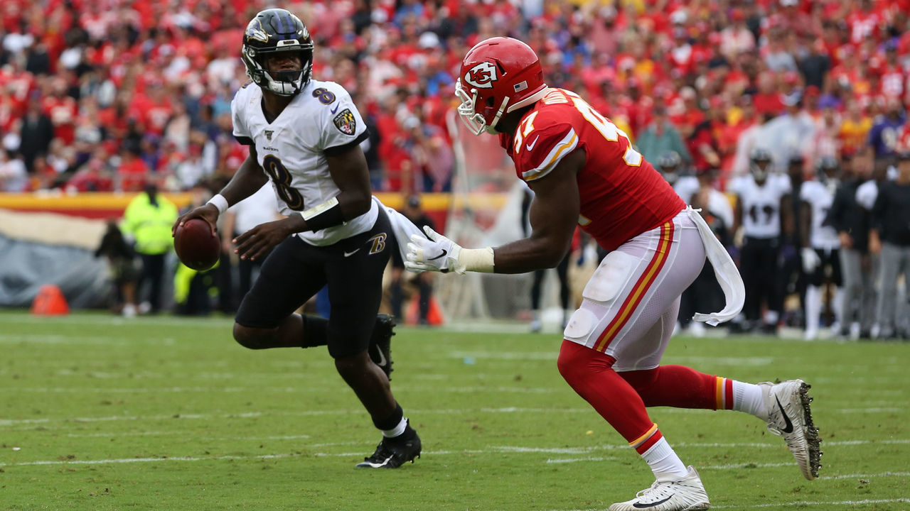 KANSAS CITY, MO - SEPTEMBER 22: Baltimore Ravens quarterback Lamar Jackson (8) looks to throw past Kansas City Chiefs defensive end Alex Okafor (97) in the fourth quarter of an AFC matchup between the Baltimore Ravens and Kansas City Chiefs on September 22, 2019 at Arrowhead Stadium in Kansas City, MO.