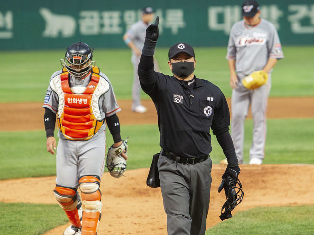 INCHEON SOUTH KOREA - MAY 7 An umpire wears a mask leads during a baseball game between SK Wyverns and Hanwha Eagles at SK Wyverns clubs Happy Dream Ballpark without spectators due to the novel coronavirus COVID-19 pandemic on May 7 2020 in Incheon South Korea The Korean Baseball League KBO begin its new season under certain rules such as obligation of wearing masks and banning spectators from stadiums