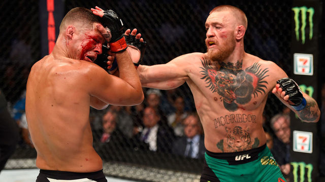 LAS VEGAS, NV - AUGUST 20: (R-L) Conor McGregor of Ireland punches Nate Diaz in their welterweight bout during the UFC 202 event at T-Mobile Arena on August 20, 2016 in Las Vegas, Nevada.