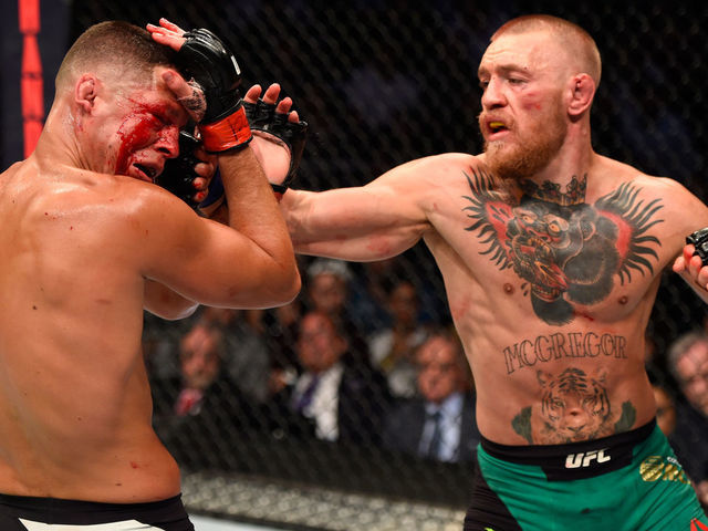 LAS VEGAS, NV - AUGUST 20: (R-L) Conor McGregor of Ireland punches Nate Diaz in their welterweight bout during the UFC 202 event at T-Mobile Arena on August 20, 2016 in Las Vegas, Nevada.