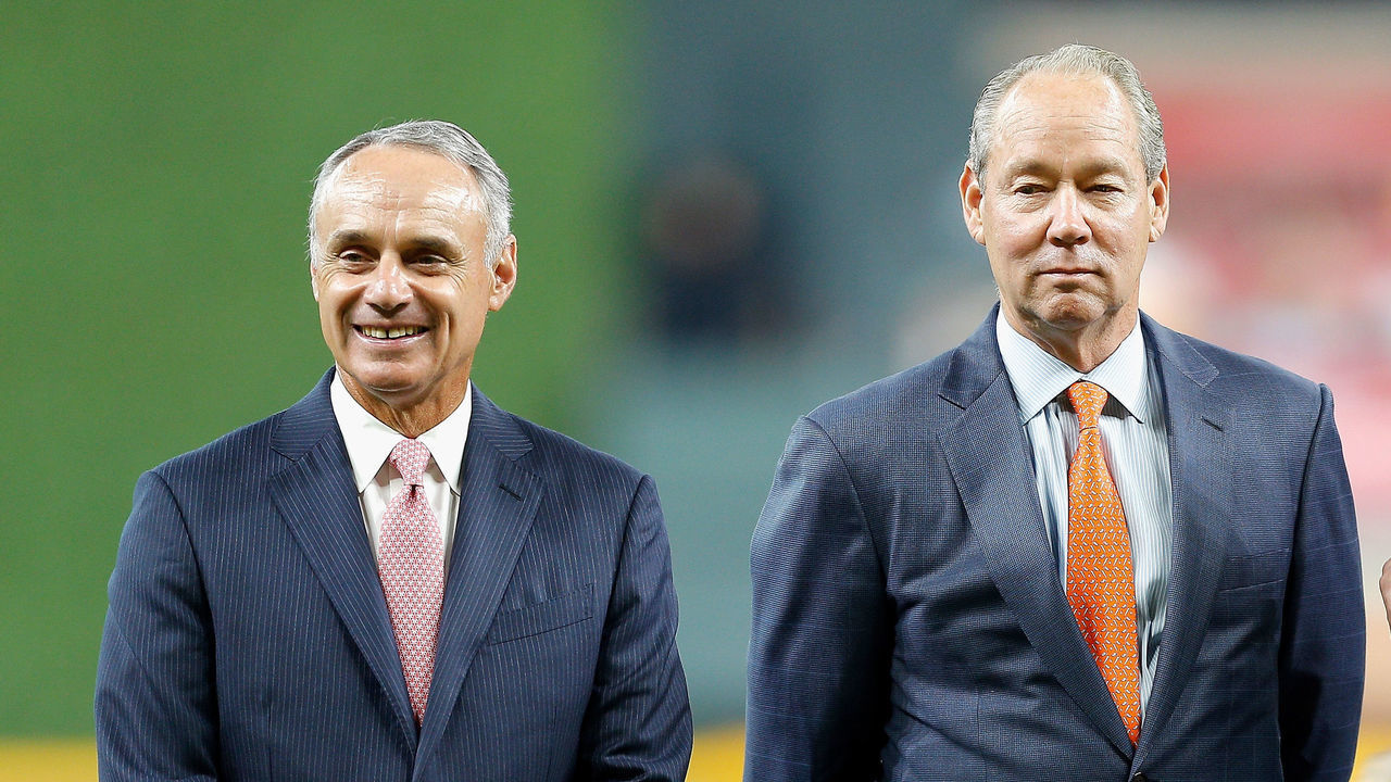 HOUSTON, TX - APRIL 03: Rob Manfred, Commissioner of Major League Baseball, left, and Houston Astros owner Jim Crane and Whitney Crane chat before ring ceremonies at Minute Maid Park on April 3, 2018 in Houston, Texas.