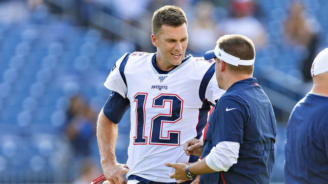NASHVILLE, TN - AUGUST 17: Tom Brady #12 talks with Offensive Coordinator Josh McDaniels of the New England Patriots before a game against the Tennessee Titans during week two of the preseason at Nissan Stadium on August 17, 2019 in Nashville, Tennessee. The Patriots defeated the Titans 22-17.