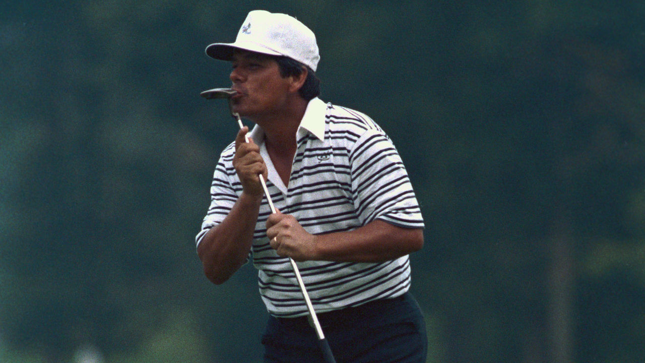 (Original Caption) Shoal Creek, Alabama: Lee Trevino gives a kiss to his putter and a bow to the crowd (August 19th) after winning the 1984 PGA Championship at the Shoal Creek course. Trevino won by four strokes.