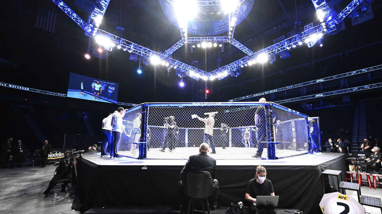 JACKSONVILLE, FLORIDA - MAY 09: UFC Octagon announcer Bruce Buffer introduces Carla Esparza of the United States and Michelle Waterson of the United States in their Women's strawweight fight during UFC 249 at VyStar Veterans Memorial Arena on May 09, 2020 in Jacksonville, Florida.