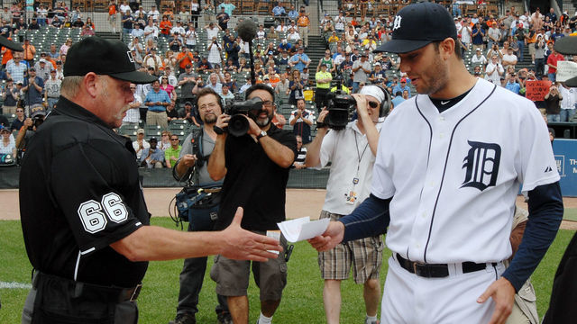 DETROIT - JUNE 03: Major League umpire Jim Joyce #66 receives the games line-up card from pitcher Armando Galarraga #58 of the Detroit Tigers before the start of the game against the Cleveland Indians at Comerica Park on June 3, 2010 in Detroit, Michigan. The Tigers defeated the Indians 12-6.