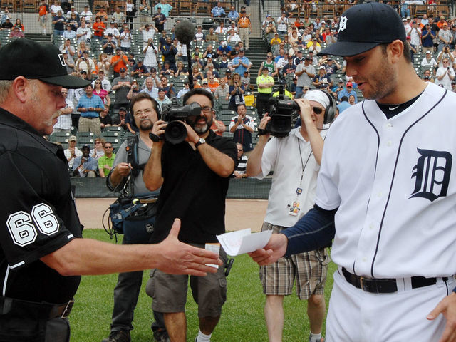 DETROIT - JUNE 03: Major League umpire Jim Joyce #66 receives the games line-up card from pitcher Armando Galarraga #58 of the Detroit Tigers before the start of the game against the Cleveland Indians at Comerica Park on June 3, 2010 in Detroit, Michigan. The Tigers defeated the Indians 12-6.
