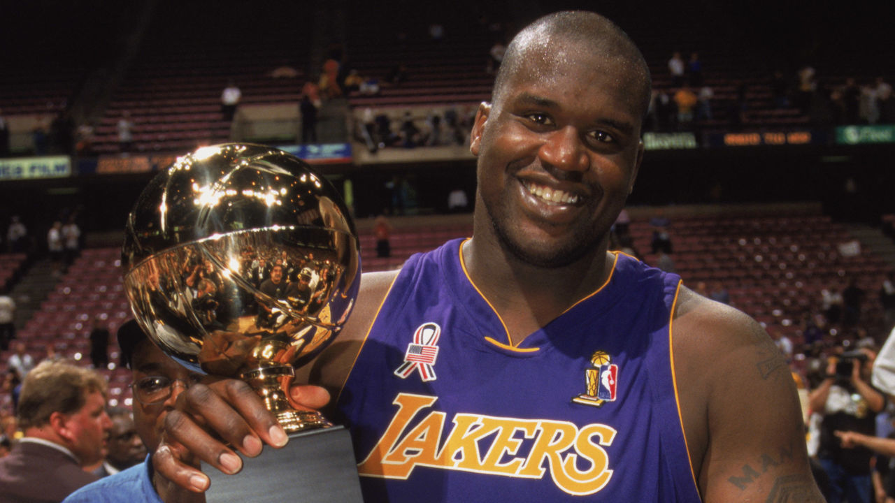 EAST RUTHERFORD, NJ - JUNE 12: Center Shaquille O'Neal #34 of the Los Angeles Lakers holds up his Series MVP trophy after Game Four of the 2002 NBA Finals against the New Jersey Nets at Continental Airlines Arena in East Rutherford, New Jersey on June 12, 2002. The Lakers defeated the Nets 113-107 and won the series 4-0. NOTE TO USER: User expressly acknowledges and agrees that, by downloading and/or using this Photograph, User is consenting to the terms and conditions of the Getty Images License Agreement Mandatory Copyright Notice: Copyright 2002 NBAE