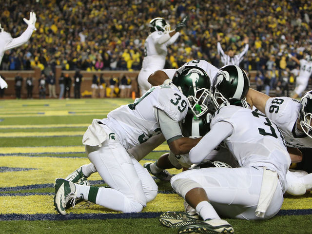 ANN ARBOR, MI - OCTOBER 17: The Michigan State Spartans celebrate in the endzone after defensive back Jalen Watts-Jackson #20 scored the game winning touchdown against the Michigan Wolverines during the final seconds of college football game at at Michigan Stadium on October 17, 2015 in Ann Arbor, Michigan.
