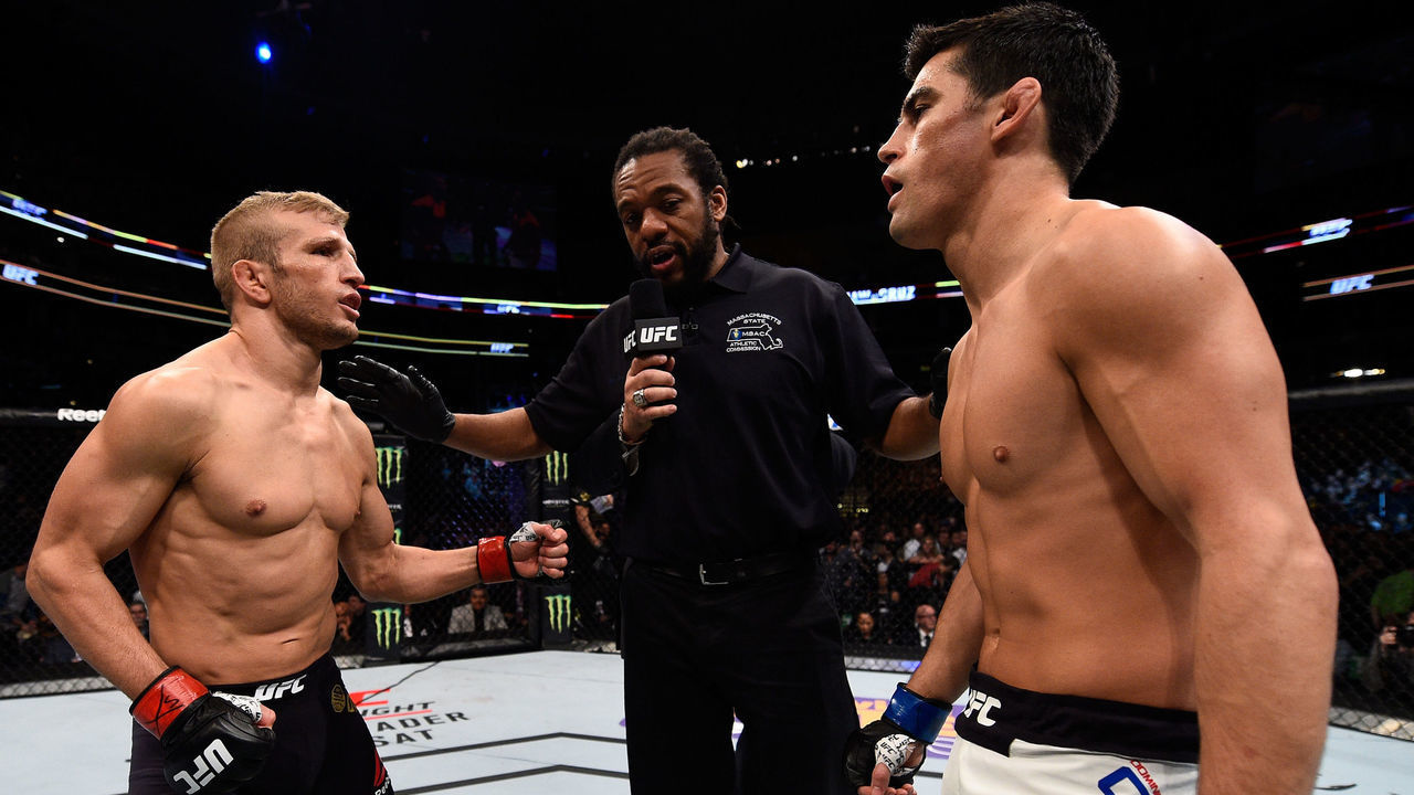BOSTON, MA - JANUARY 17: (L-R) Opponents TJ Dillashaw and Dominick Cruz receive final instructions from referee Herb Dean before their UFC bantamweight championship bout during the UFC Fight Night event inside TD Garden on January 17, 2016 in Boston, Massachusetts.