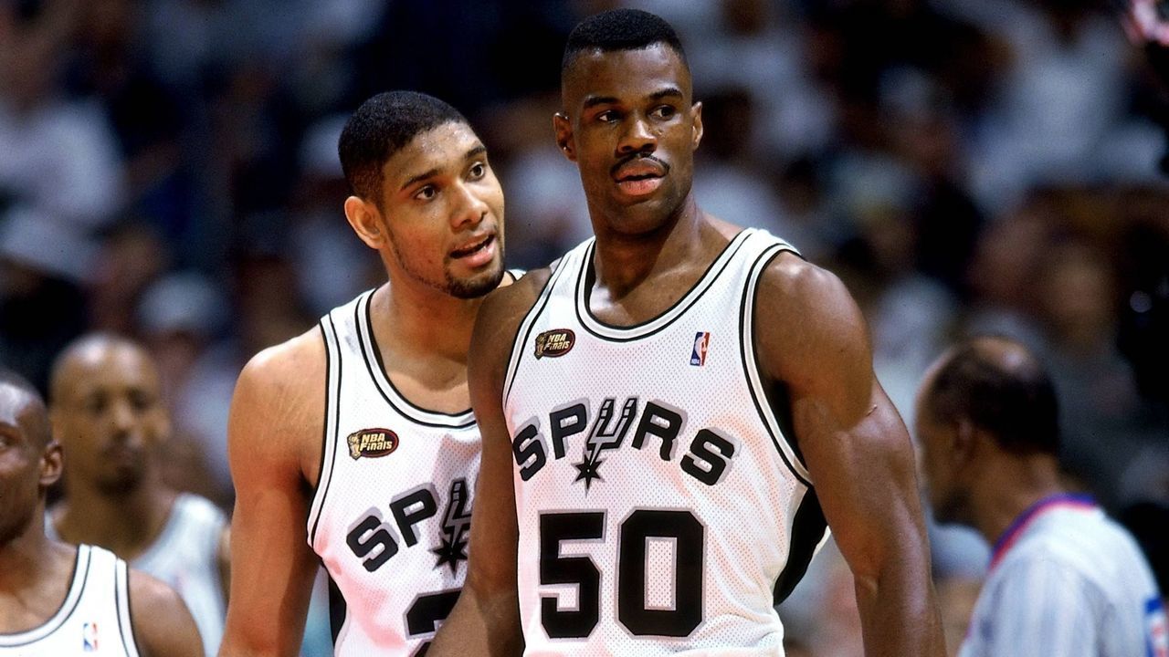 SAN ANTONIO - JUNE 16: Tim Duncan #21 and David Robinson #50 of the San Antonio Spurs talk during Game One of the 1999 NBA Finals played at the Alamodome on June 16, 1999 in San Antonio, Texas. NOTE TO USER: User expressly acknowledges that, by downloading and or using this photograph, User is consenting to the terms and conditions of the Getty Images License agreement. Mandatory Copyright Notice: Copyright 1999 NBAE
