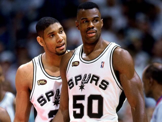 SAN ANTONIO - JUNE 16: Tim Duncan #21 and David Robinson #50 of the San Antonio Spurs talk during Game One of the 1999 NBA Finals played at the Alamodome on June 16, 1999 in San Antonio, Texas. NOTE TO USER: User expressly acknowledges that, by downloading and or using this photograph, User is consenting to the terms and conditions of the Getty Images License agreement. Mandatory Copyright Notice: Copyright 1999 NBAE