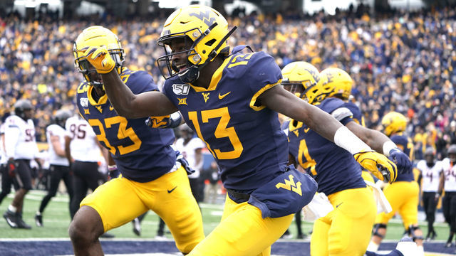 MORGANTOWN, WV - NOVEMBER 23: West Virginia Mountaineers Wide Receiver Sam James (13) celebrates making a gain to the goal line during the first half of the college football game between the Oklahoma Cowboys and the West Virginia Mountaineers on November 23, 2019, at Milan Puskar Stadium in Morgantown, WV.