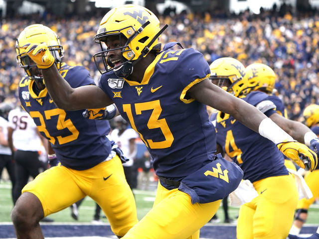 MORGANTOWN, WV - NOVEMBER 23: West Virginia Mountaineers Wide Receiver Sam James (13) celebrates making a gain to the goal line during the first half of the college football game between the Oklahoma Cowboys and the West Virginia Mountaineers on November 23, 2019, at Milan Puskar Stadium in Morgantown, WV.