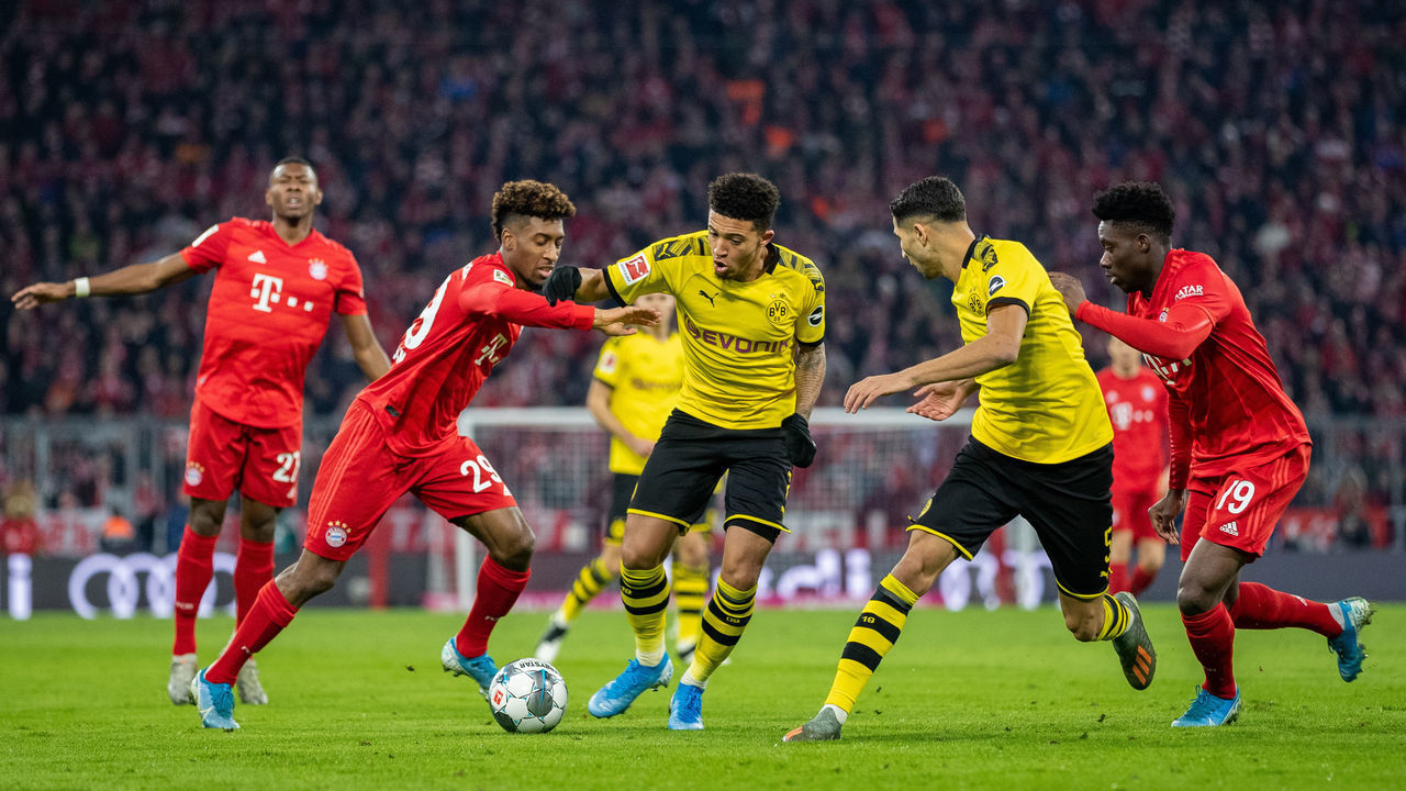 MUNICH, GERMANY - NOVEMBER 09: Jadon Sancho of Borussia Dortmund and Achraf Hakimi of Borussia Dortmund battle for the ball with Alphonso Davies of FC Bayern Muenchen and Kingsley Coman of FC Bayern Muenchen during the Bundesliga match between FC Bayern Muenchen and Borussia Dortmund at Allianz Arena on November 09, 2019 in Munich, Germany.