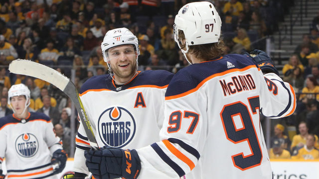 NASHVILLE, TN - MARCH 02: Edmonton Oilers center Connor McDavid (97) celebrates a third period goal by center Leon Draisaitl (29) during the NHL game between the Nashville Predators and Edmonton Oilers, held on March 2, 2020, at Bridgestone Arena in Nashville, Tennessee.