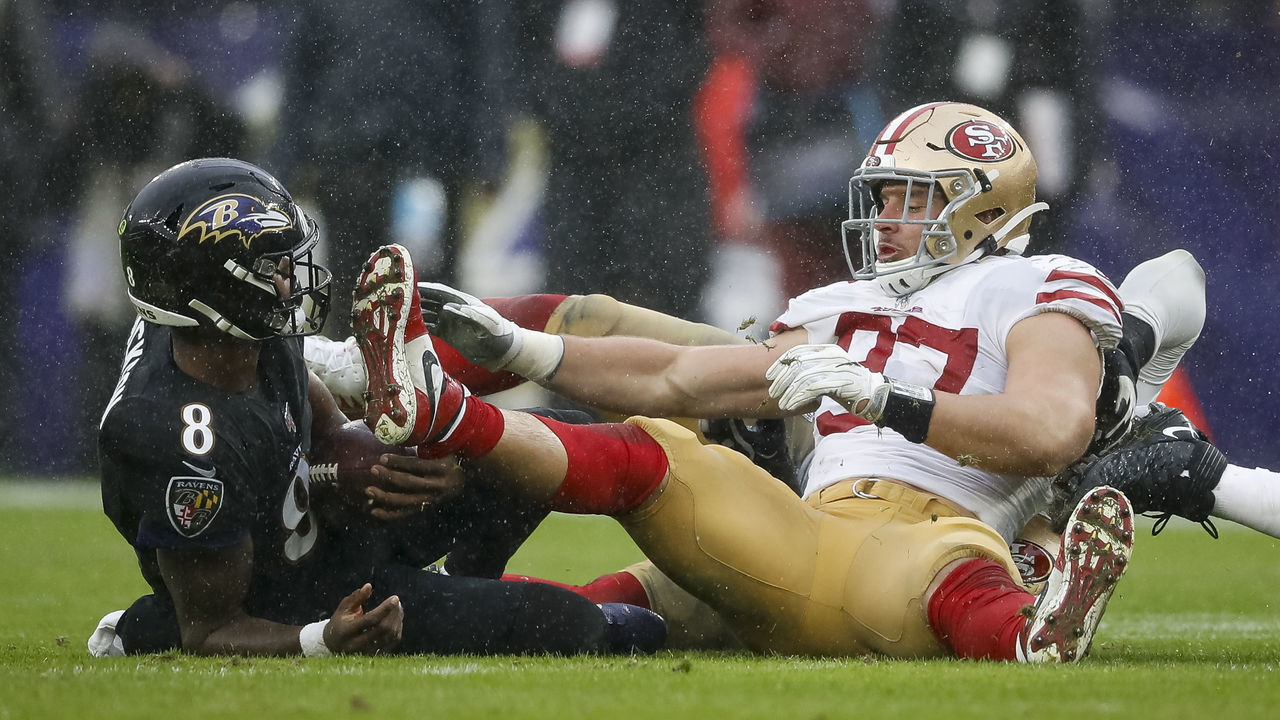 BALTIMORE, MD - DECEMBER 01: Lamar Jackson #8 of the Baltimore Ravens is tackled by Nick Bosa #97 of the San Francisco 49ers during the first half at M&T Bank Stadium on December 1, 2019 in Baltimore, Maryland.