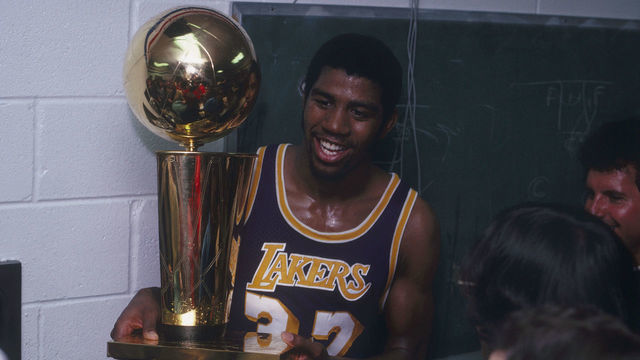 PHILADELPHIA, PA - MAY 16: Magic Johnson #32 of the Los Angeles Lakers celebrates with the Walter A. Brown championship trophy after winning Game 6 and the series against the Philadelphia 76ers on May 16, 1980 at the Spectrum in Philadelphia, Pennsylvania. (Photo by Focus on Sport via Getty Images