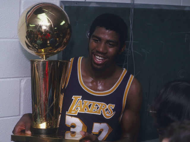 PHILADELPHIA, PA - MAY 16: Magic Johnson #32 of the Los Angeles Lakers celebrates with the Walter A. Brown championship trophy after winning Game 6 and the series against the Philadelphia 76ers on May 16, 1980 at the Spectrum in Philadelphia, Pennsylvania. (Photo by Focus on Sport via Getty Images