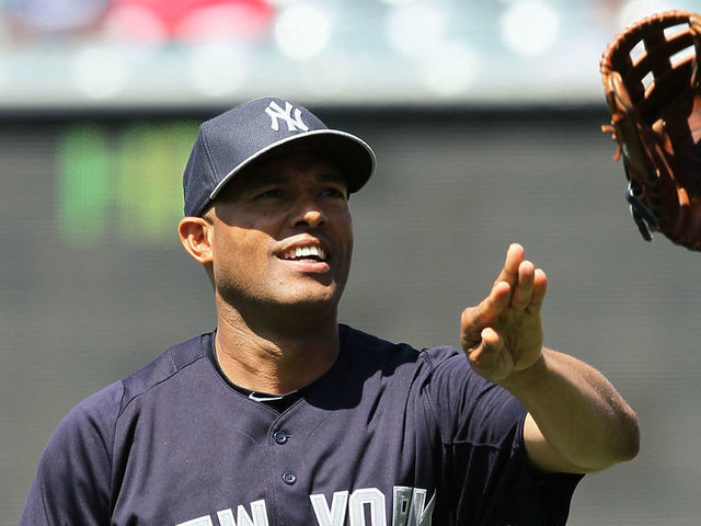 ANAHEIM, CA - JUNE 15: Pitcher Mariano Rivera #42 of the New York Yankees tosses his glove to a trainer prior to the MLB game against the Los Angeles Angels of Anaheim at Angel Stadium of Anaheim on June 15, 2013 in Anaheim, California. The Angels defeated the Yankees 6-2.