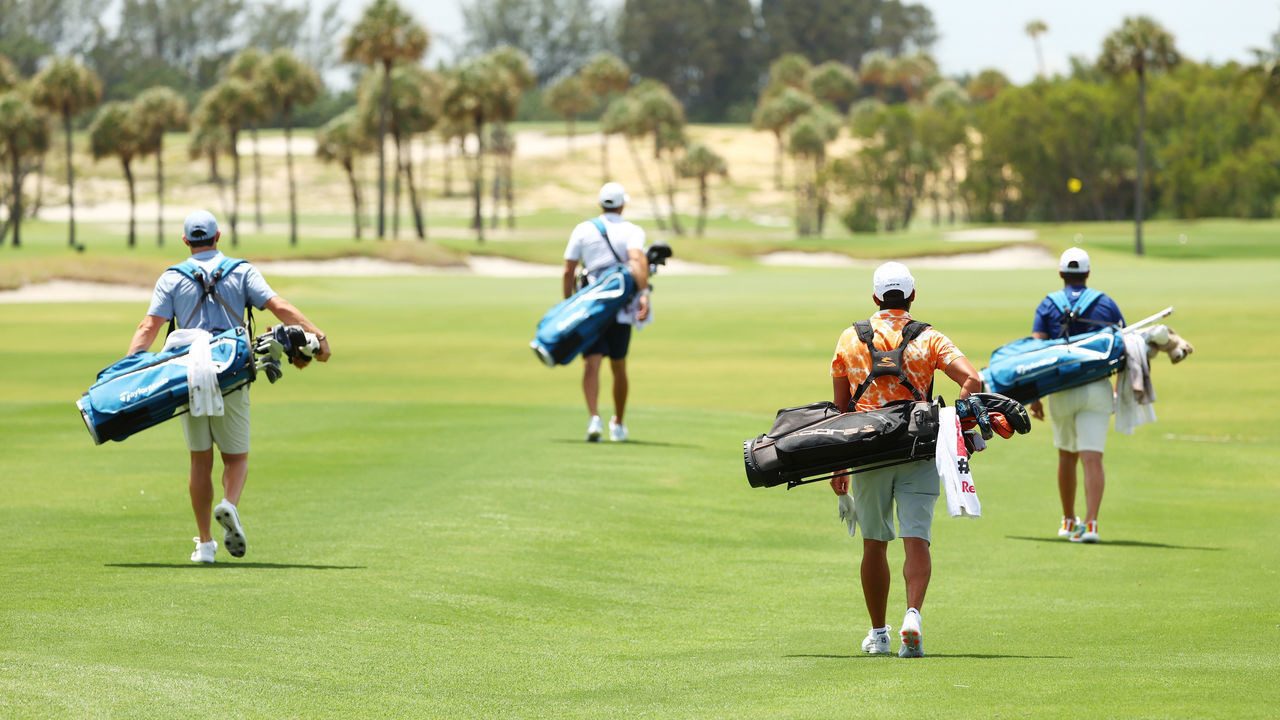 JUNO BEACH, FLORIDA - MAY 17: (L-R) Rory McIlroy of the American Nurses Foundation team, Dustin Johnson of the American Nurses Foundation team, Rickie Fowler of the CDC Foundation team and Matthew Wolff of the CDC Foundation team walk down the first fairway during the TaylorMade Driving Relieve Supported By UnitedHealth Group on May 17, 2020 at Seminole Golf Club in Juno Beach, Florida.