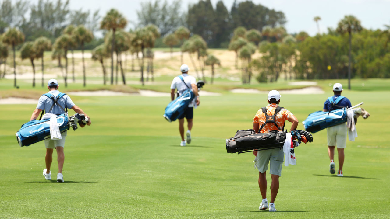 JUNO BEACH, FLORIDA - MAY 17: (L-R) Rory McIlroy of the American Nurses Foundation team, Dustin Johnson of the American Nurses Foundation team, Rickie Fowler of the CDC Foundation team and Matthew Wolff of the CDC Foundation team walk down the first fairway during the TaylorMade Driving Relief Supported By UnitedHealth Group on May 17, 2020 at Seminole Golf Club in Juno Beach, Florida.