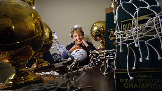 BOULDER, COLORADO--MARCH 3, 2005--Ceal Barry, CU women's basketball head coach who stepped down after 22 years earlier this week, poses with just a few of the trophies she has won throughout her career including her 500th victory ball. Barry, who is CU's winningest coach, will become an assistant athletic director at CU after the season.