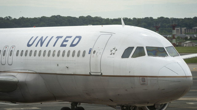 ARLINGTON, VA - MAY 05: A United Airlines plane sits at a gate Ronald Reagan Washington National Airport, May 5, 2020 in Arlington, Virginia. According to leaked internal memos, United Airlines plans to cut at least 3,400 management and administrative positions in October and potentially lay off up to 30 percent of their pilots.