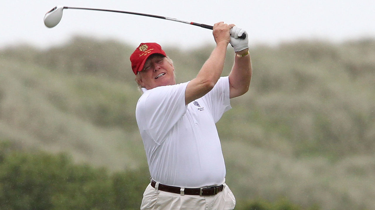 Donald Trump hits a tee shot on the tenth hole of the Trump International Golf Links golf course near Aberdeen after officially opening it this morning.