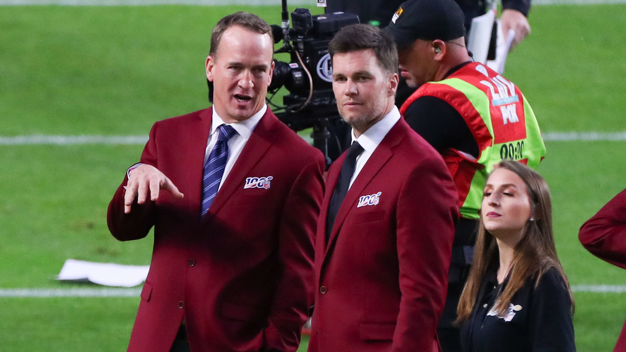 MIAMI GARDENS, FL - FEBRUARY 02: Tom Brady and Peyton Manning talk on the field during the 100 year team celebration prior to Super Bowl LIV on February 2, 2020 at Hard Rock Stadium in Miami Gardens, FL.