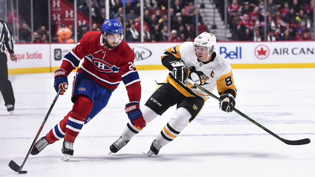 MONTREAL, QC - OCTOBER 13: Phillip Danault #24 of the Montreal Canadiens skates the puck against Sidney Crosby #87 of the Pittsburgh Penguins during the NHL game at the Bell Centre on October 13, 2018 in Montreal, Quebec, Canada. The Montreal Canadiens defeated the Pittsburgh Penguins 4-3 in a shootout.