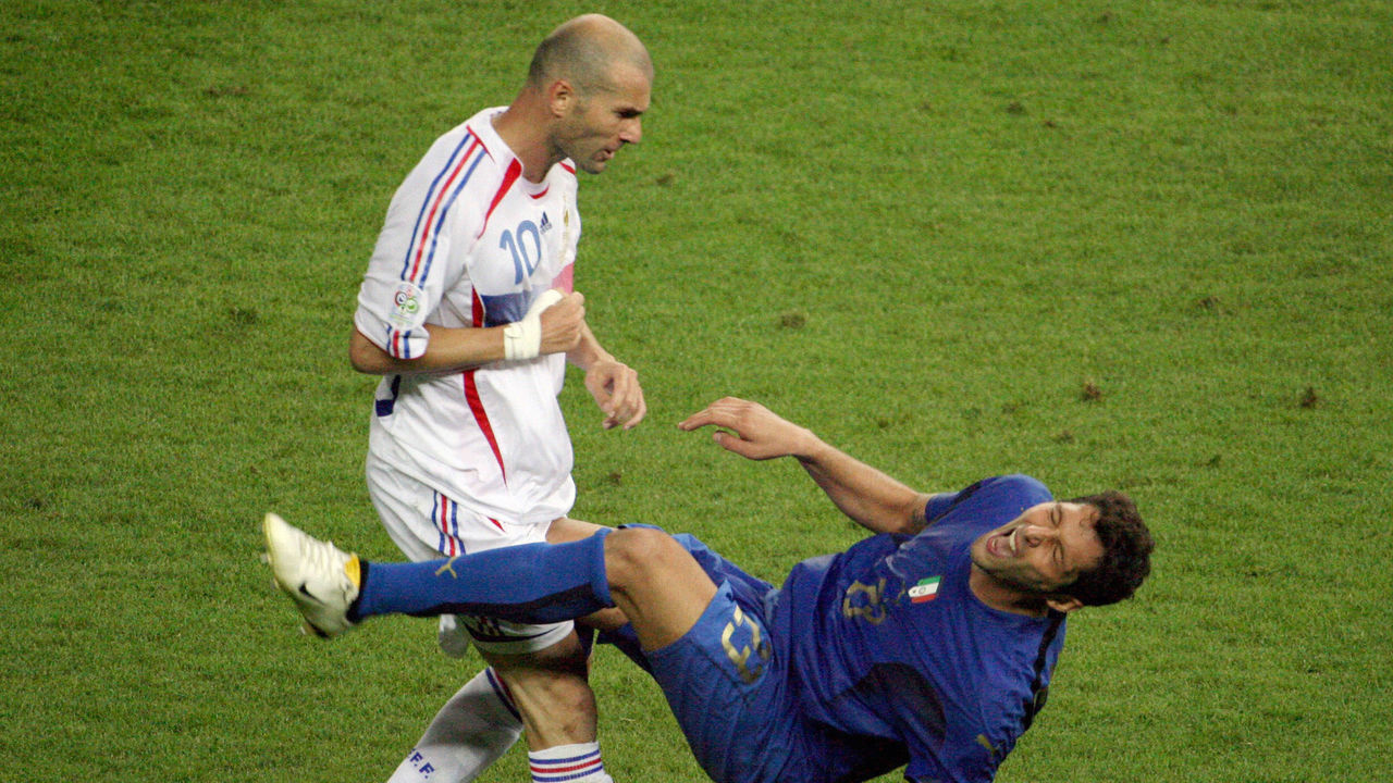 (FILES) This file picture taken on July 9, 2006 shows former France's midfielder Zinedine Zidane (L) gesturing after head-butting Italian defender Marco Materazzi during the World Cup 2006 final football match between Italy and France at Berlin?s Olympic Stadium in Germany. Italy's World Cup-winning defender Marco Materazzi on Monday April 7, 2008 accepted an apology and damages from a British newspaper over claims he used racist abuse to goad Zinedine Zidane into headbutting him. AFP PHOTO /JOHN MACDOUGALL/FILES