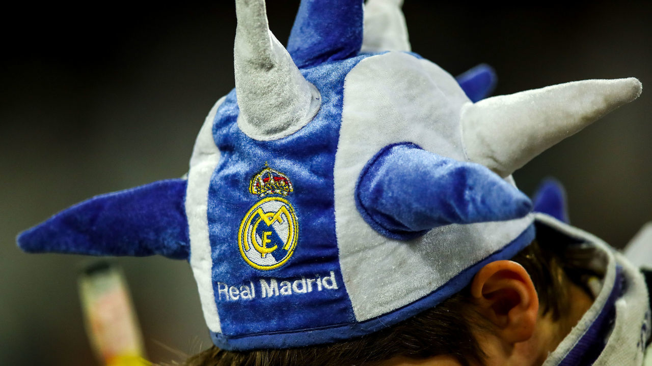 MADRID, SPAIN - FEBRUARY 26: A fan of Real Madrid wearing a branded jester hat during the UEFA Champions League round of 16 first leg match between Real Madrid and Manchester City at Bernabeu on February 26, 2020 in Madrid, Spain.