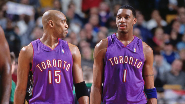 BOSTON, MA - MARCH 1: Vince Carter #15 and Tracy McGrady #1 of the Toronto Raptors chats against the Boston Celtics on March 1, 2000 at the Fleet Center in Boston, Massachusetts. NOTE TO USER: User expressly acknowledges and agrees that, by downloading and/or using this photograph, user is consenting to the terms and conditions of the Getty Images License Agreement. Mandatory Copyright Notice: Copyright 2000 NBAE