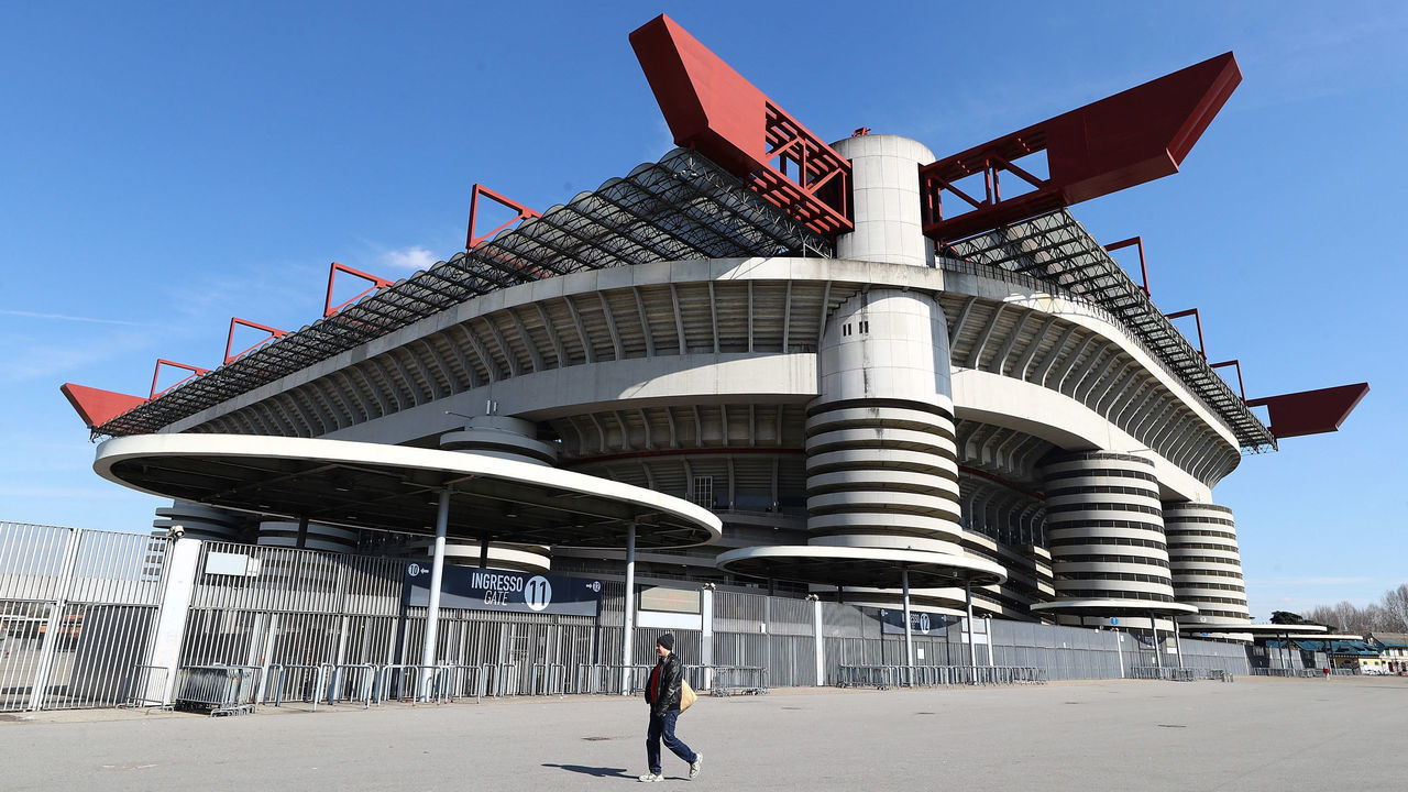 MILAN, ITALY - MARCH 08: A man walks past the closed stadium after rules to limit the spread of Covid-19 have been put in place before the Serie A match between AC Milan and Genoa CFC at Stadio Giuseppe Meazza (also known as the San Siro stadium) on March 8, 2020 in Milan, Italy.