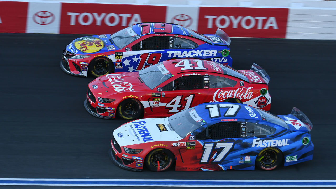 CHARLOTTE, NC - MAY 26: Ricky Stenhouse Jr., Roush Fenway Racing, Ford Mustang Fastenal (17), Daniel Suarez, Stewart-Haas Racing, Ford Mustang Coca-Cola (41) and Martin Truex, Jr., Joe Gibbs Racing, Toyota Camry Bass Pro Shops/TRACKER ATVs & Boats/USO (19) race three wide during the 60th Annual Monster Energy Cup Series Coca-Cola 600 on May 26, 2019, at Charlotte Motor Speedway in Concord, NC.