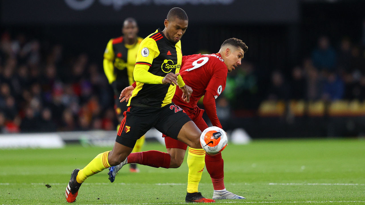 WATFORD, ENGLAND - FEBRUARY 29: Christian Kabasele of Watford battles for possession with Roberto Firmino of Liverpool during the Premier League match between Watford FC and Liverpool FC at Vicarage Road on February 29, 2020 in Watford, United Kingdom.