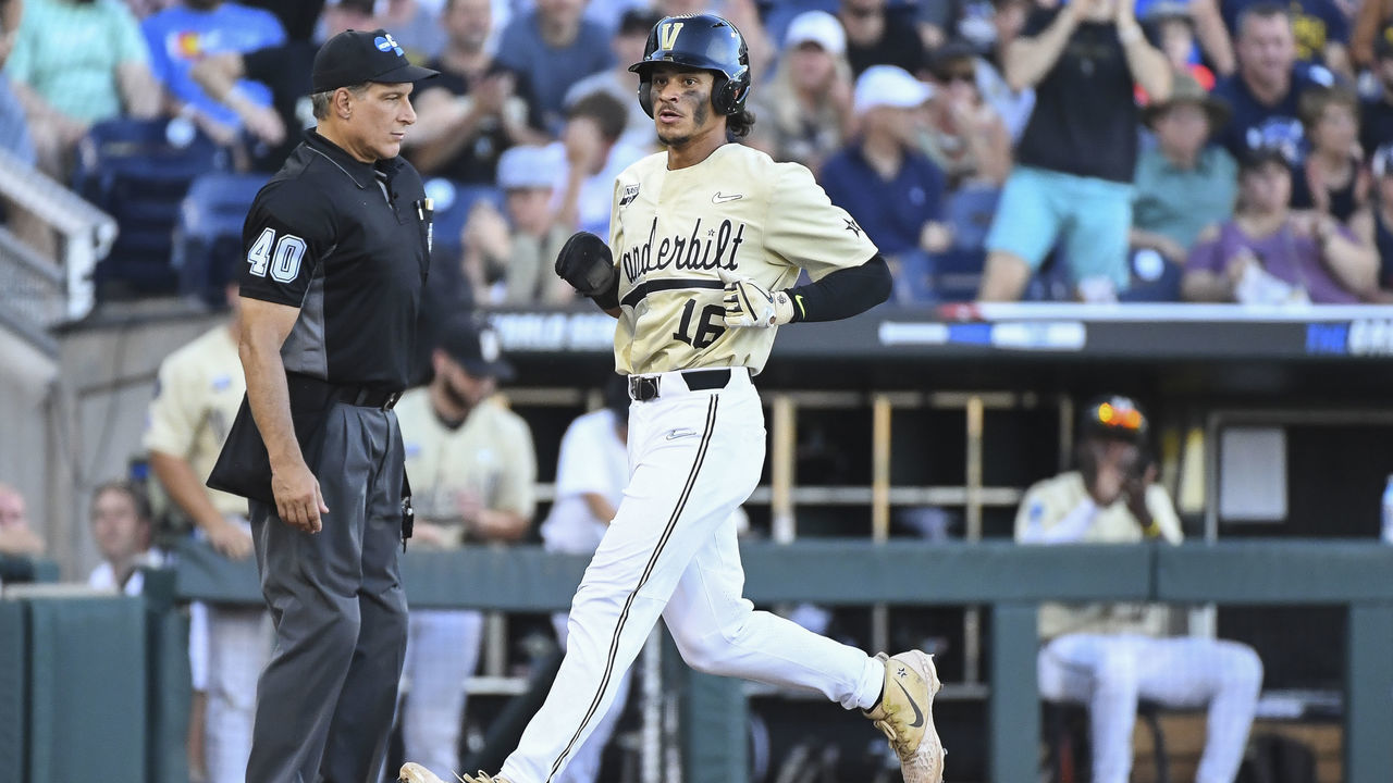 OMAHA, NE - JUNE 26: Austin Martin #16 of the Vanderbilt Commodores scores a run against the Michigan Wolverines during the Division I Men's Baseball Championship held at TD Ameritrade Park Omaha on June 26, 2019 in Omaha, Nebraska.