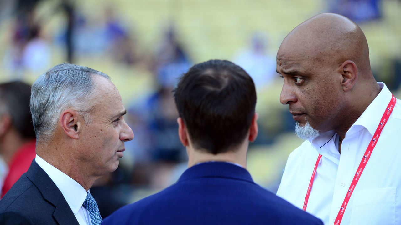 LOS ANGELES, CA - OCTOBER 25: Major League Baseball Commissioner Robert D. Manfred Jr. talks with Executive Director of the Major League Baseball Players Association Tony Clark during batting practice prior to Game 2 of the 2017 World Series between the Houston Astros and the Los Angeles Dodgers at Dodger Stadium on Wednesday, October 25, 2017 in Los Angeles, California.