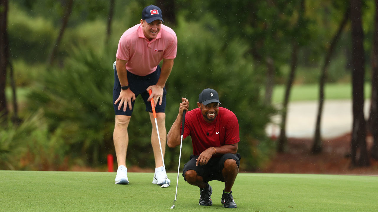 HOBE SOUND, FLORIDA - MAY 24: Tiger Woods and former NFL player Peyton Manning read a putt on the sixth green during The Match: Champions For Charity at Medalist Golf Club on May 24, 2020 in Hobe Sound, Florida.